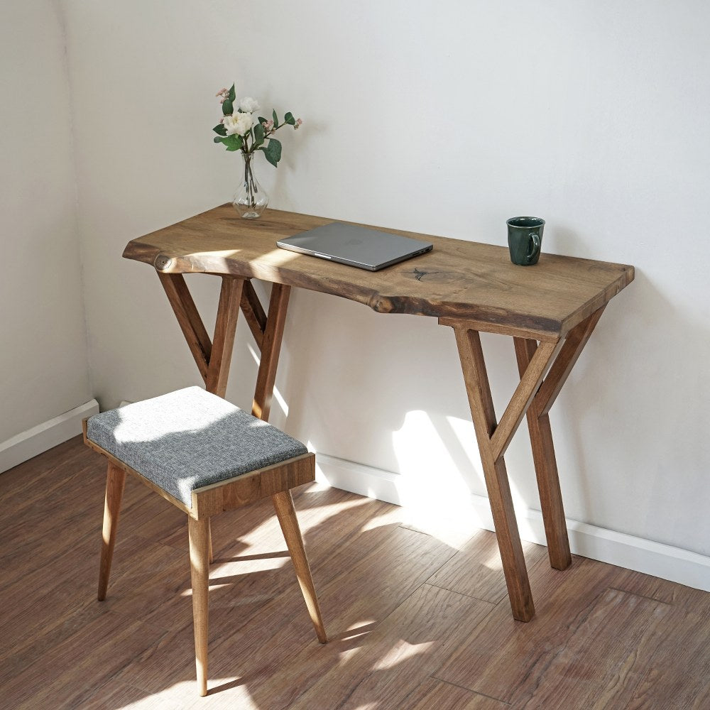 Small live edge walnut desk featuring a laptop on its surface, showcasing natural wood grain and a minimalist design.