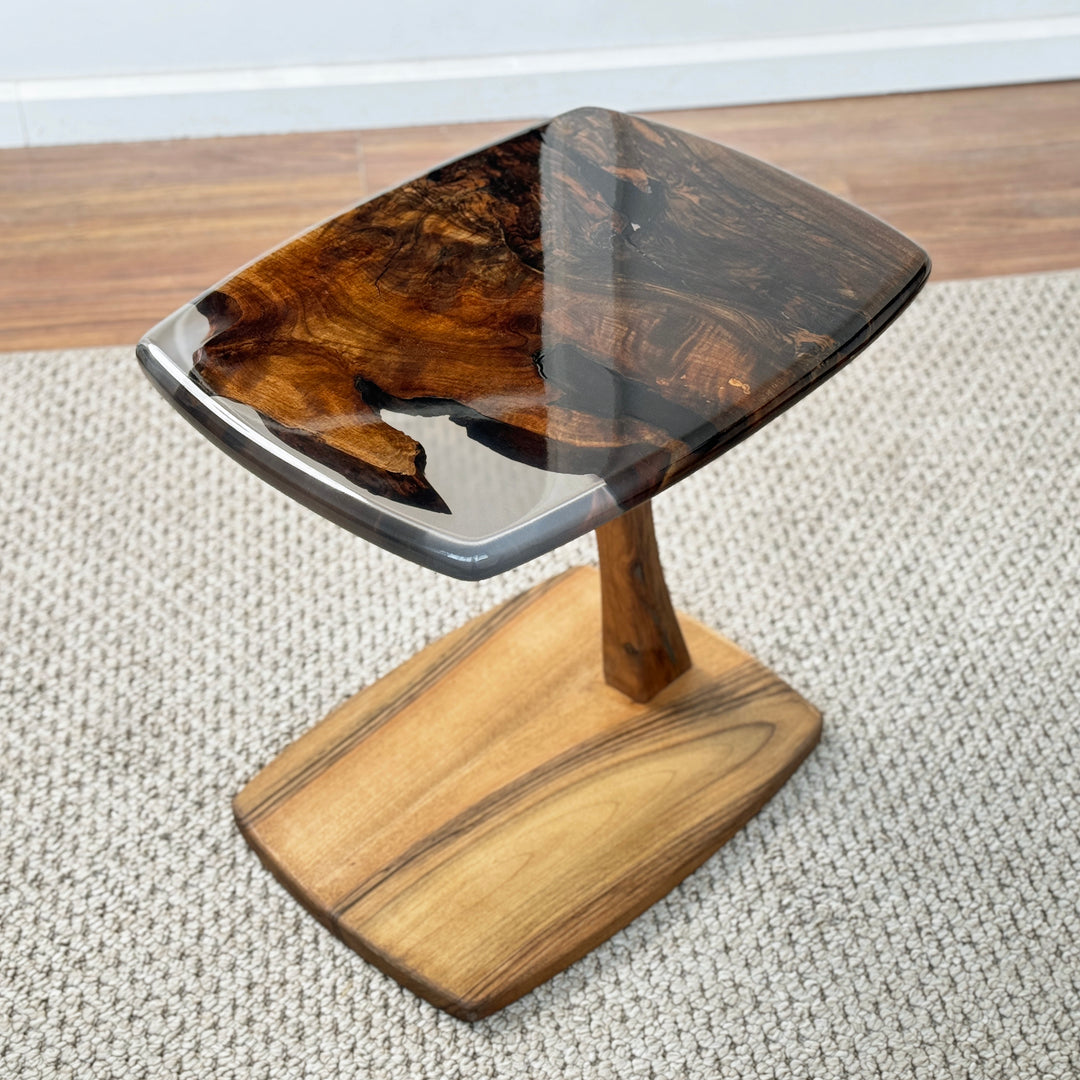 Side table with C shaped base and epoxy accents