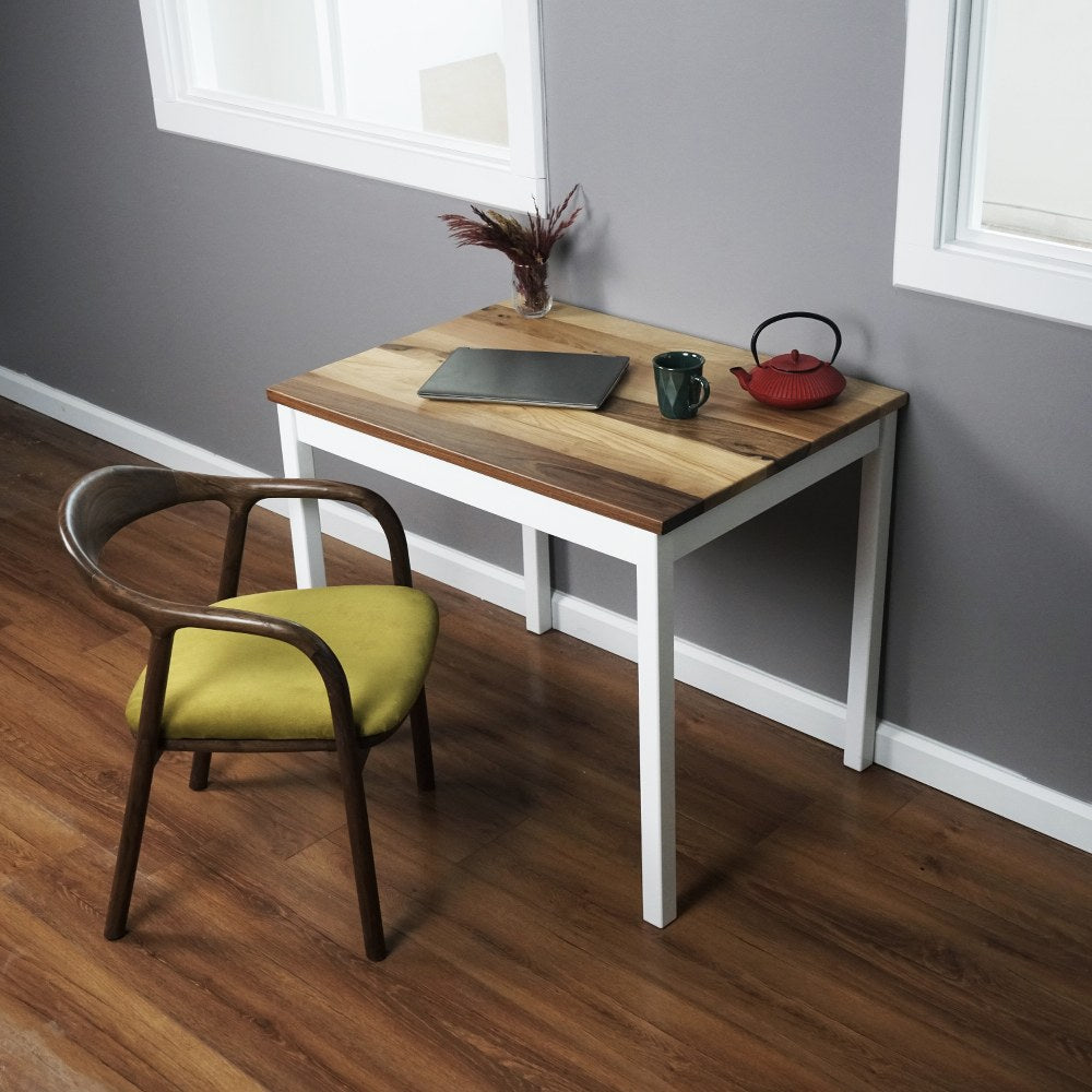 Small Scandinavian walnut desk with wooden legs, featuring a laptop and chair in a cozy room setting.