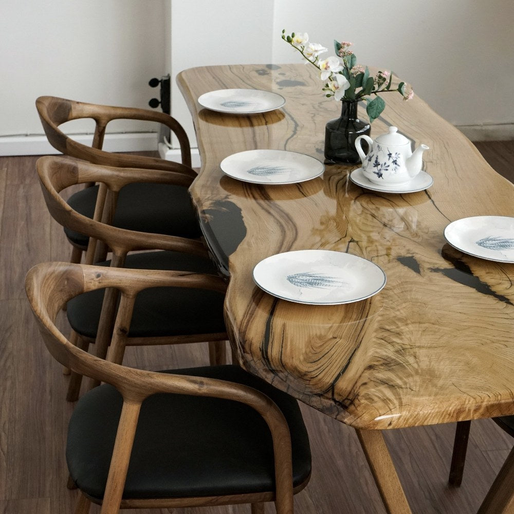 Wood chair back view showcasing curved walnut frame and cushioned seat