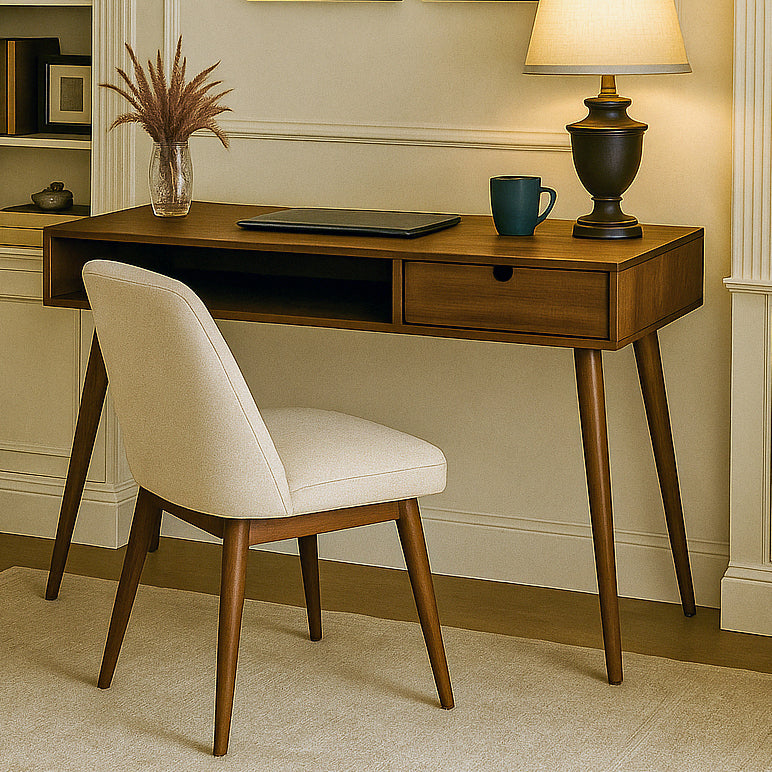 Walnut boho desk with a drawer, open cubby and tapered legs beside an upholstered chair in a study