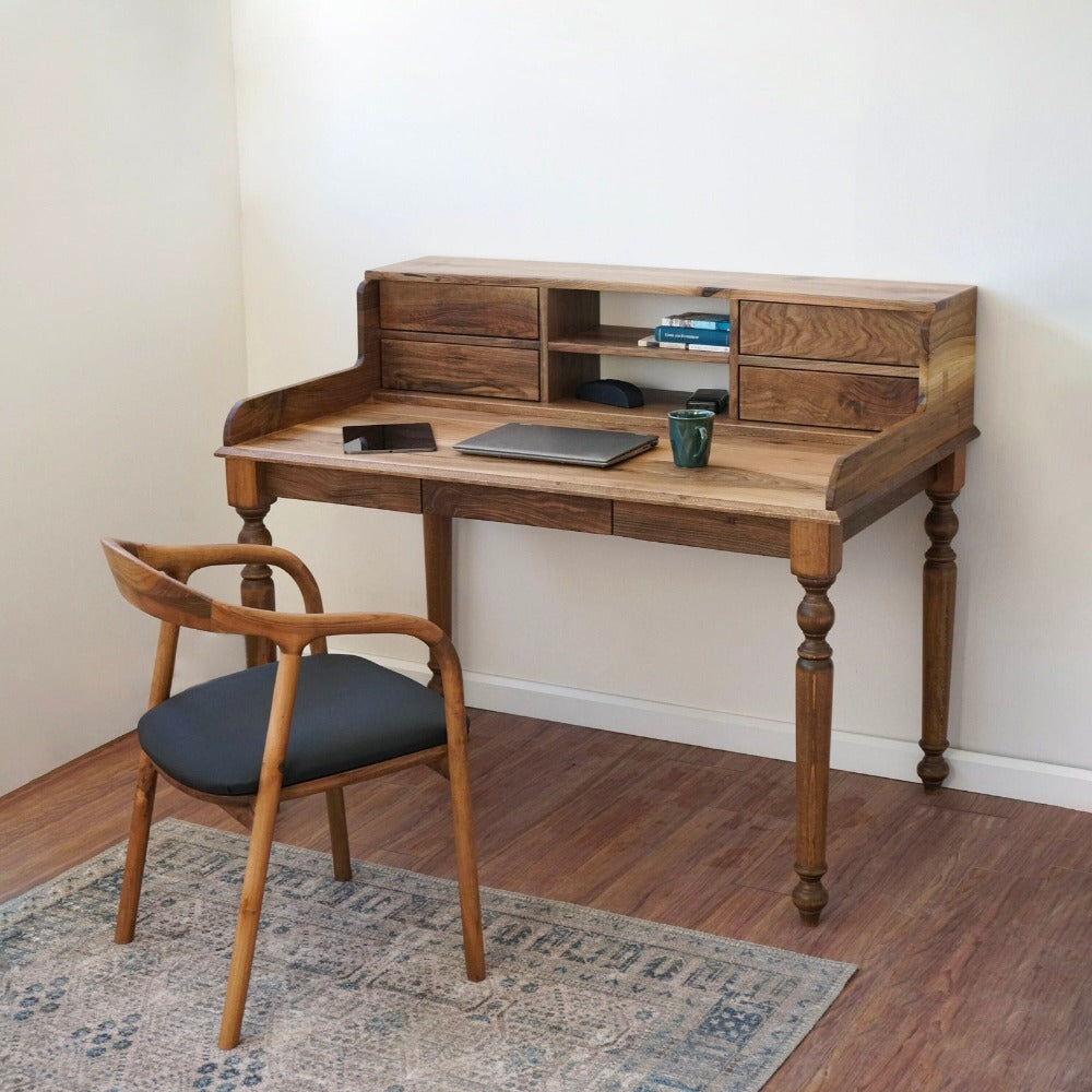Walnut writing desk with a hutch of four drawers and an open center shelf, turned legs, and a wooden armchair on a patterned rug