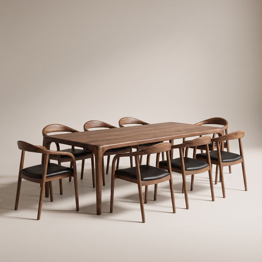 Oslo walnut dining table set for eight with curved back armchairs and black leather seats