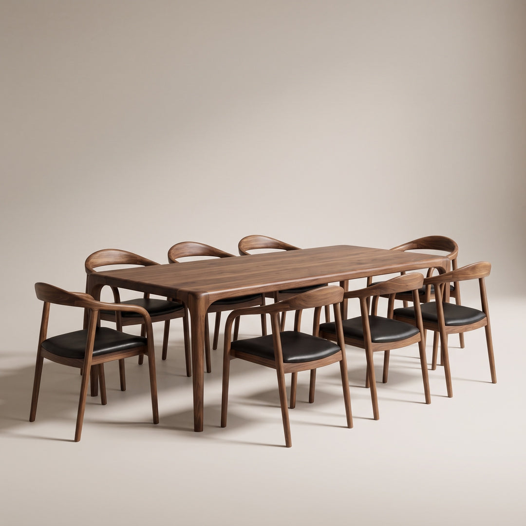 Oslo walnut dining table set for eight with curved back armchairs and black leather seats