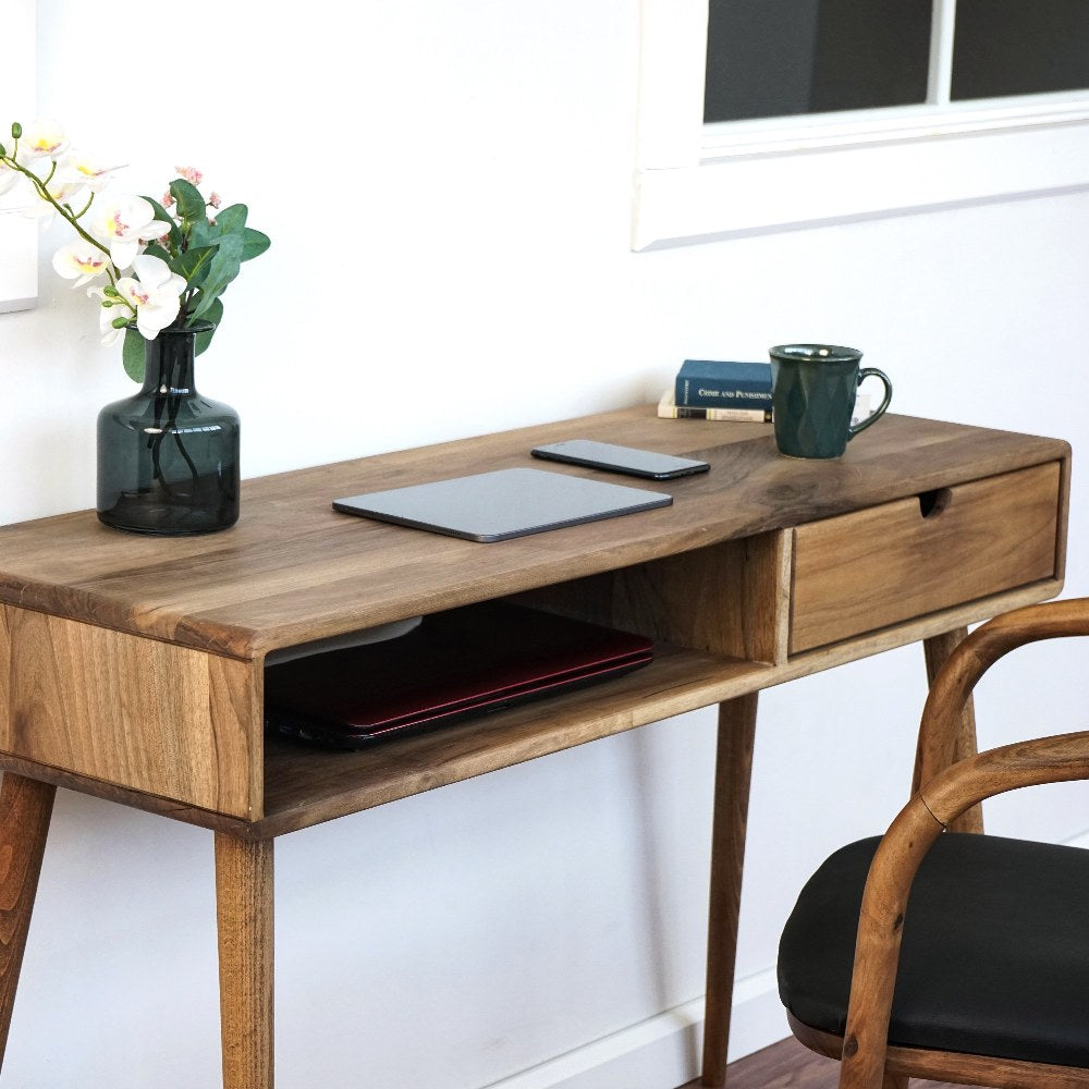 Close-up of the open cubby, drawer and tapered leg on the walnut desk from the left
