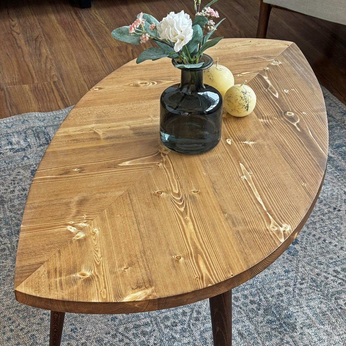 Close-up of the chevron plank pattern on the leaf shaped coffee table top, three-quarter view