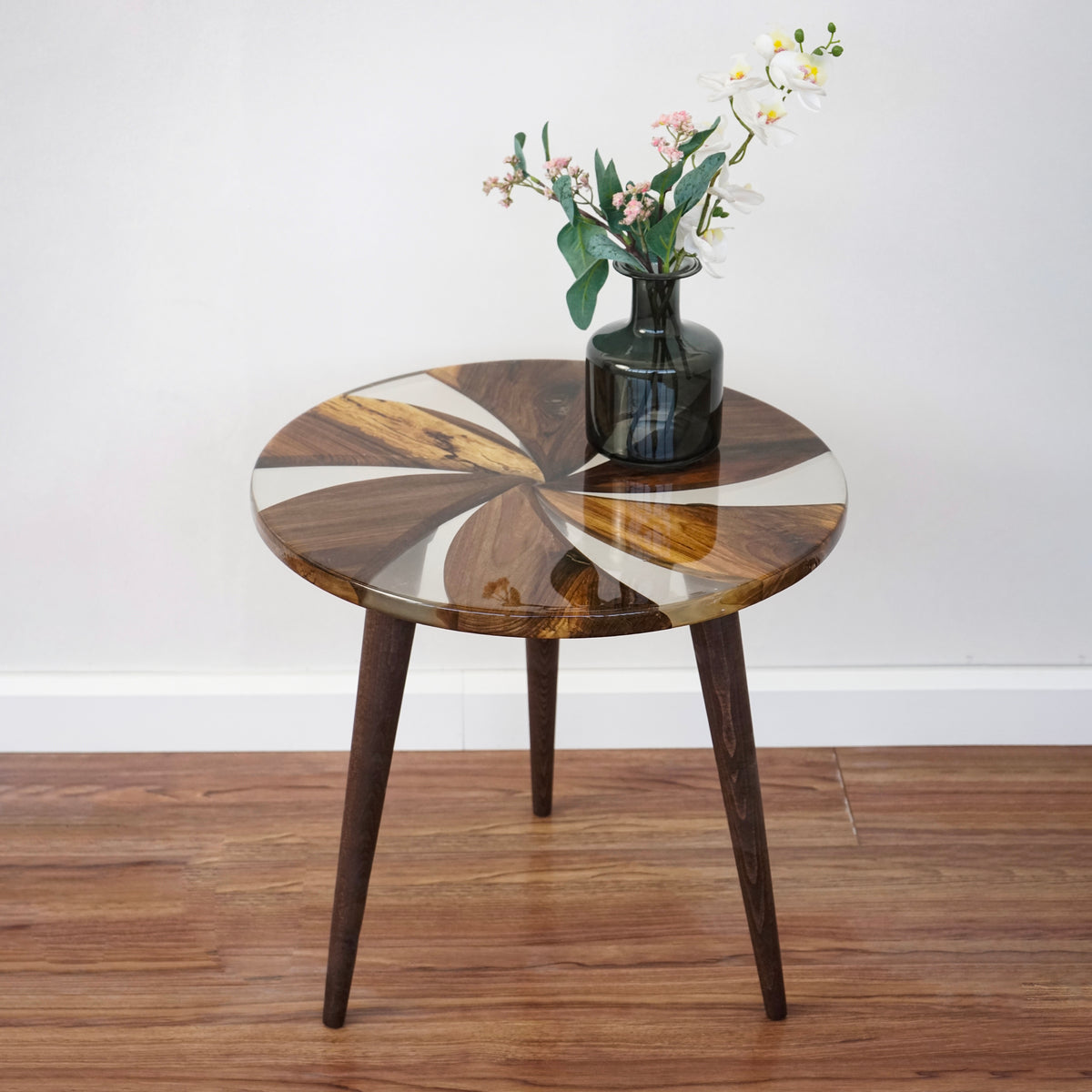 Walnut windmill side table with epoxy inlay and tapered legs, wide front view with a vase of flowers