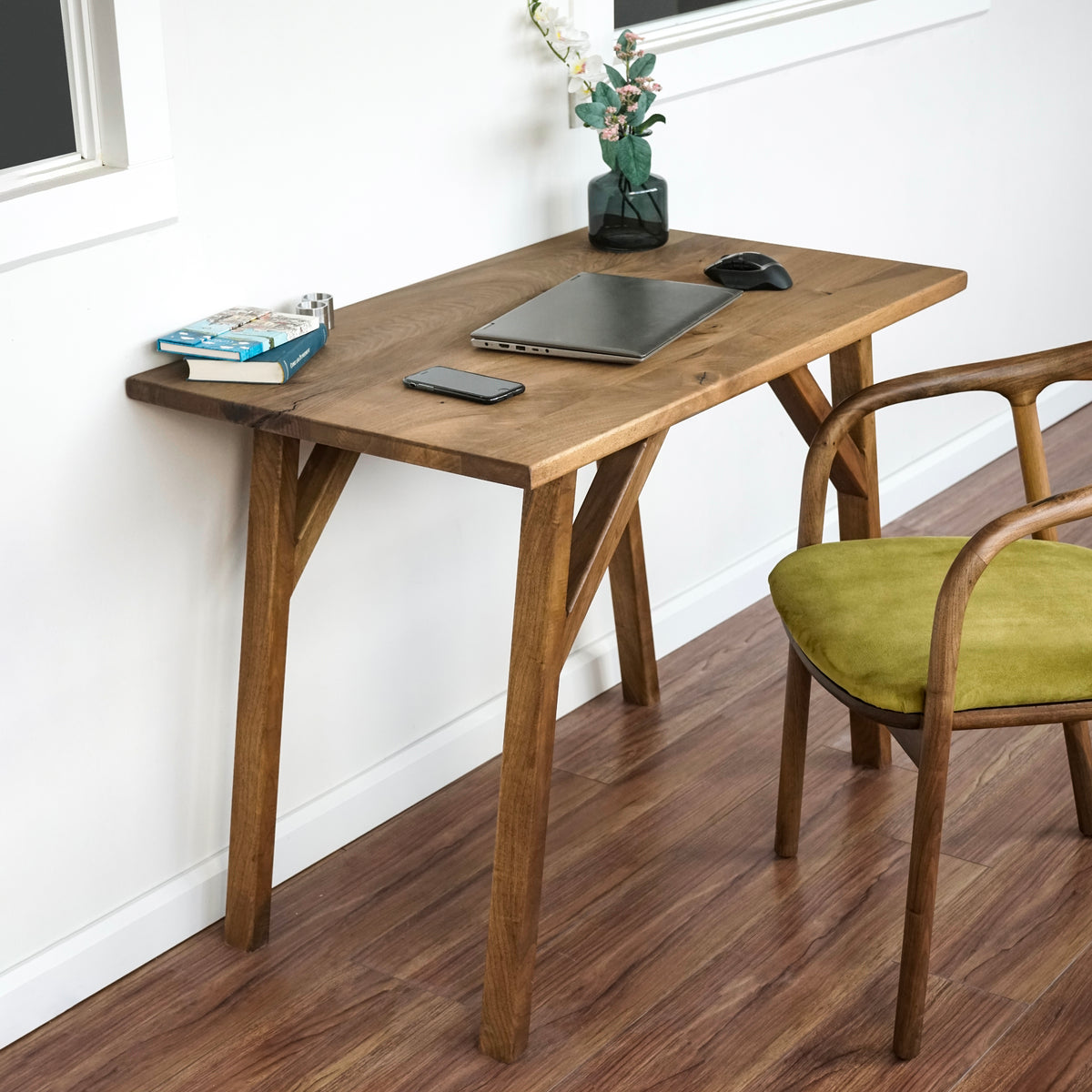 Small walnut desk with a straight front edge and Y-shaped legs, side view with a green-seat chair at the right