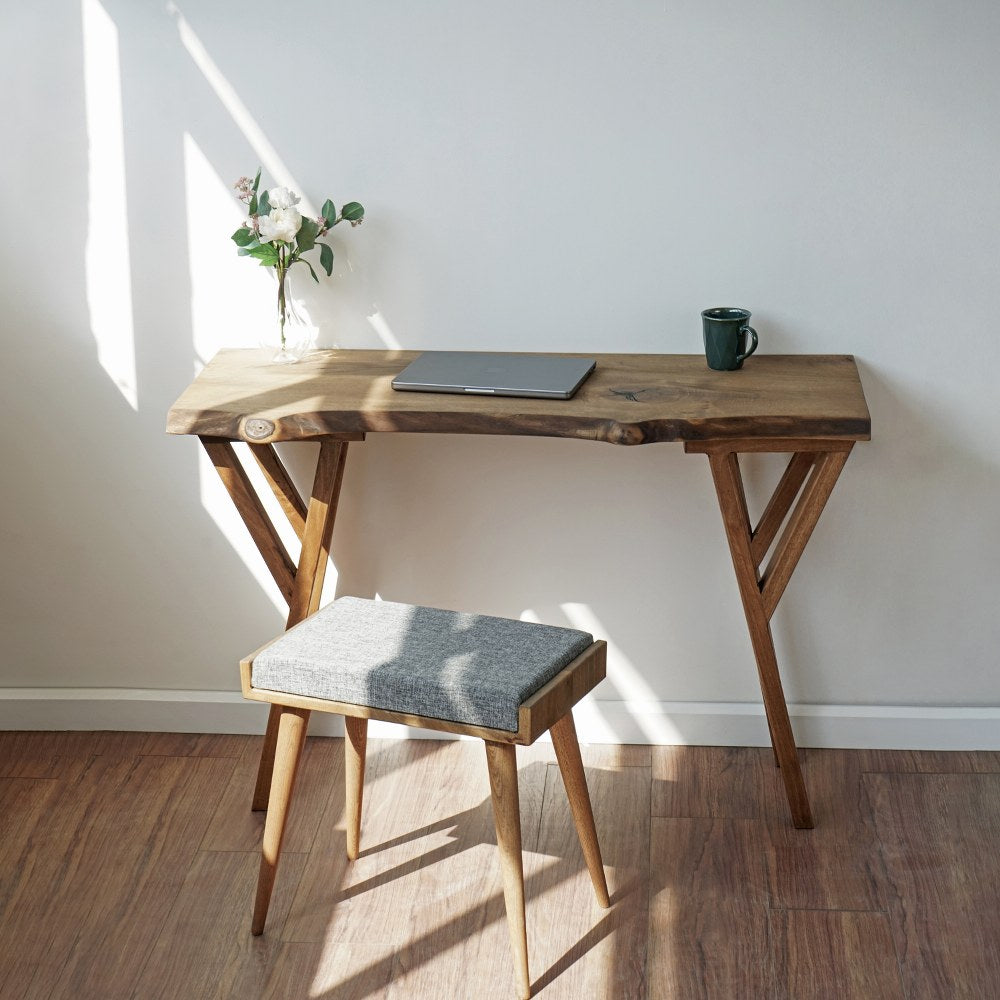 Front view of the live edge walnut desk with Y-shaped wooden legs and a laptop on top