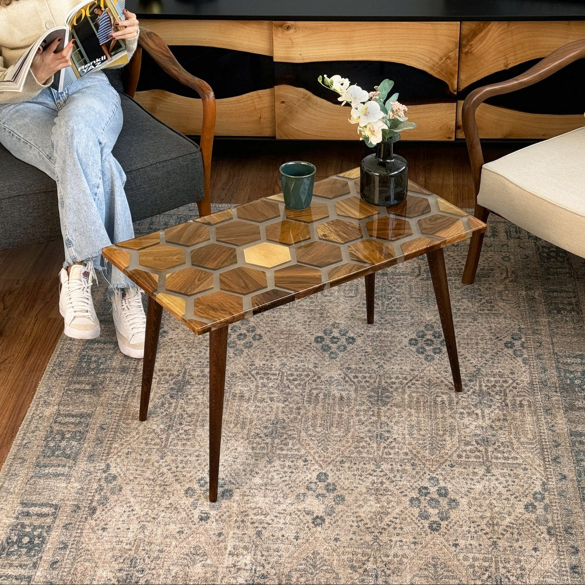 Honeycomb walnut epoxy coffee table seen from the right side with a mug and vase on top