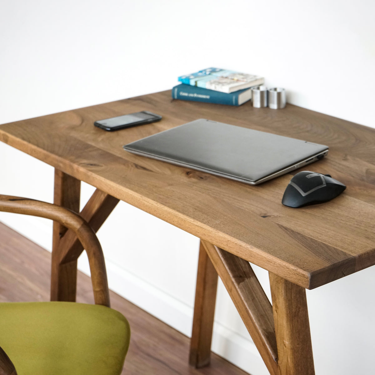Close-up of the rectangle-edge walnut desk top with a laptop, mouse and phone