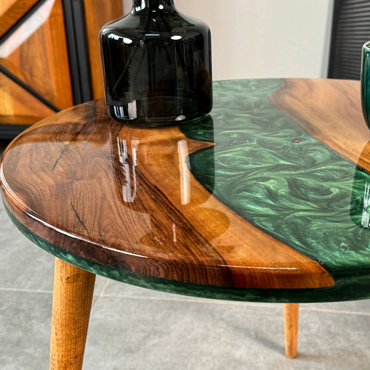 Close-up of the green epoxy river and walnut edge on the round side table top