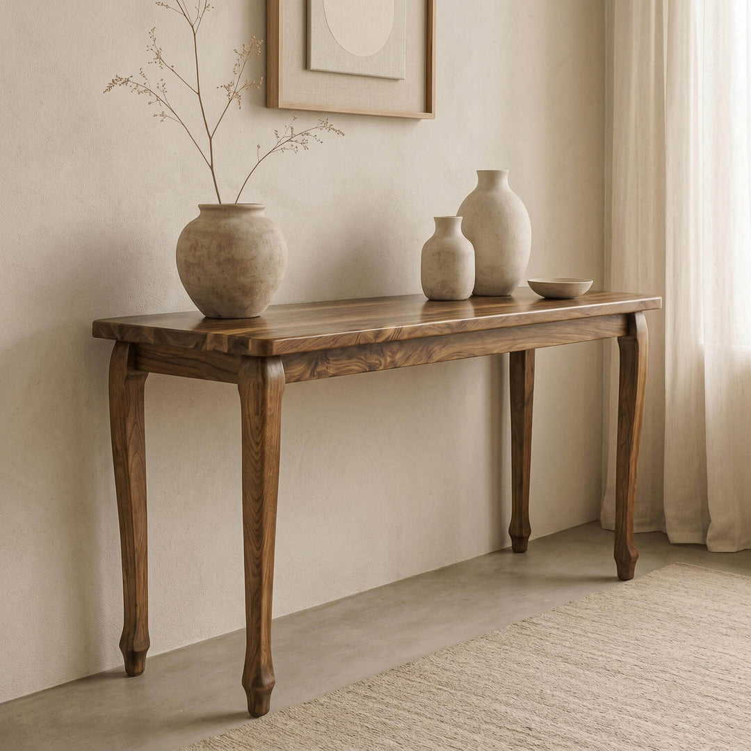 Premium cabriole legged walnut console table highlighting organic wood grain patterns in a serene interior layout.