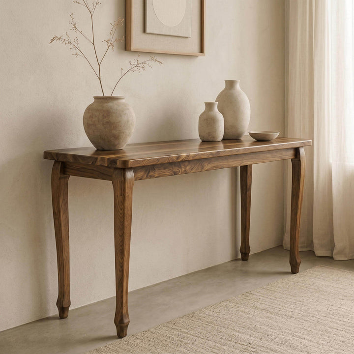 Premium cabriole legged walnut console table highlighting organic wood grain patterns in a serene interior layout.