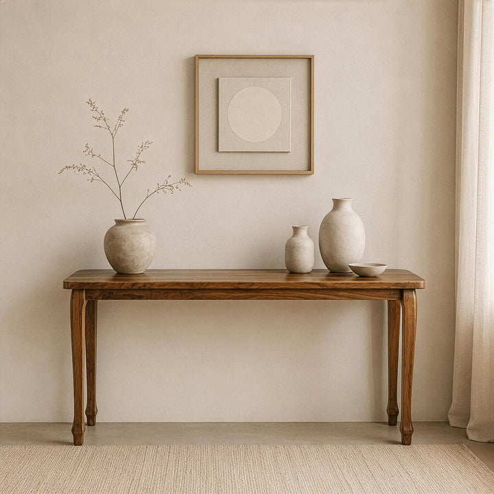 Cabriole legged walnut console table featuring classic curved legs and a polished wood surface styled with minimalist ceramic vases.