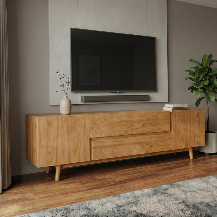 Wooden TV stand with a television mounted on a wall in a living room setting.