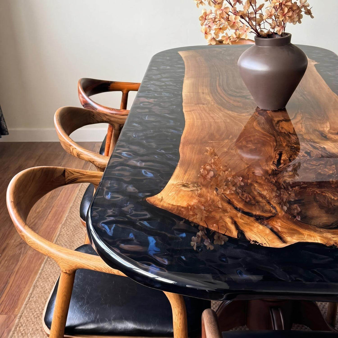 Oval epoxy walnut table drawing attention with its traditional classic legged structure and a glamorous glossy tabletop.