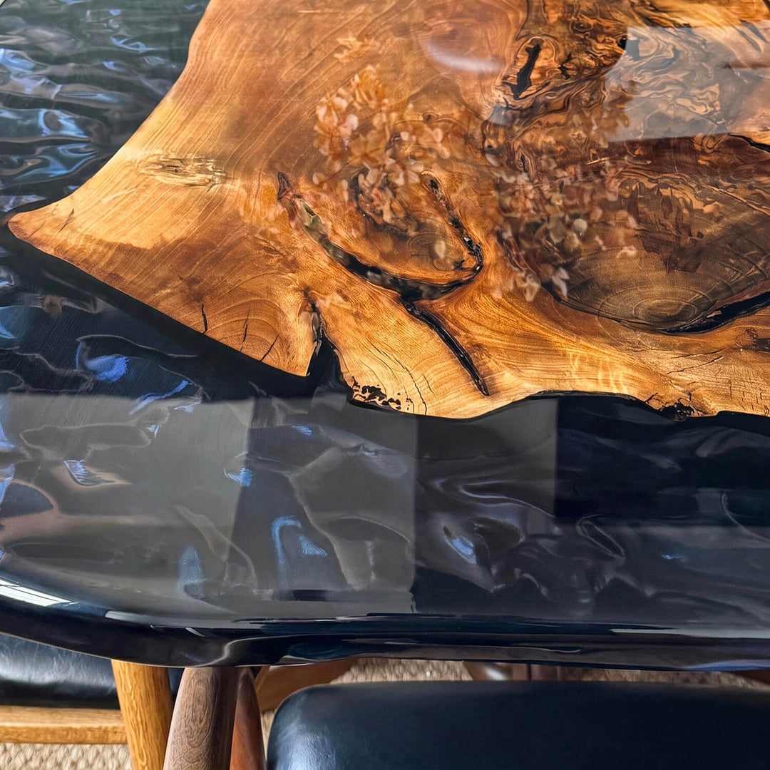 Comfortable and luxurious classic legged epoxy walnut table positioned on a textured rug in an aesthetically pleasing, sunlit interior.