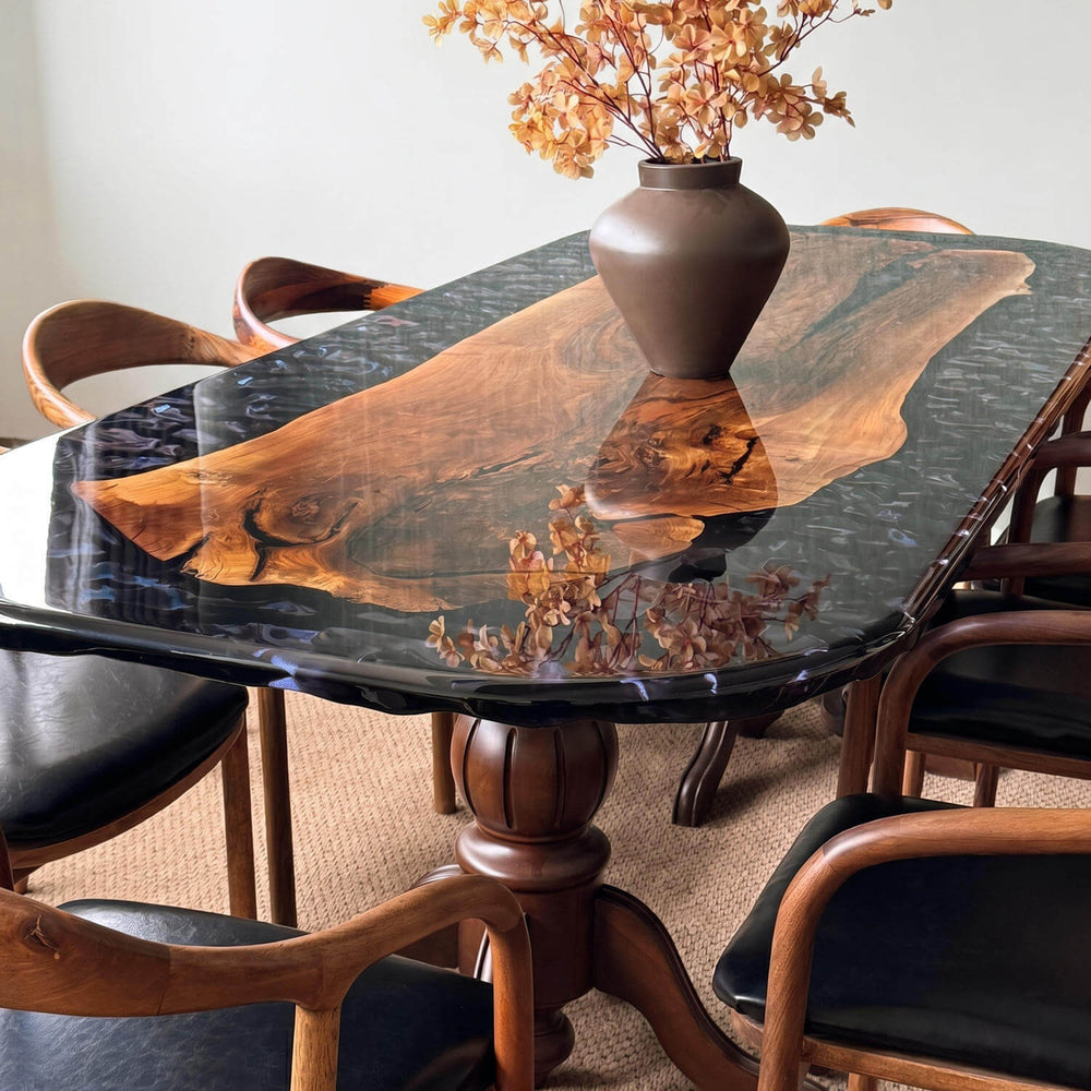 Luxury epoxy walnut table combining natural live-edge wood with fluid epoxy, displayed alongside modern matching chairs.