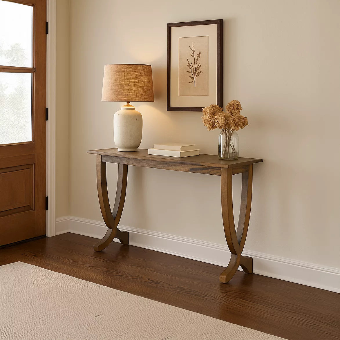 Wider view of the walnut entryway console table with curved legs next to a door with a window