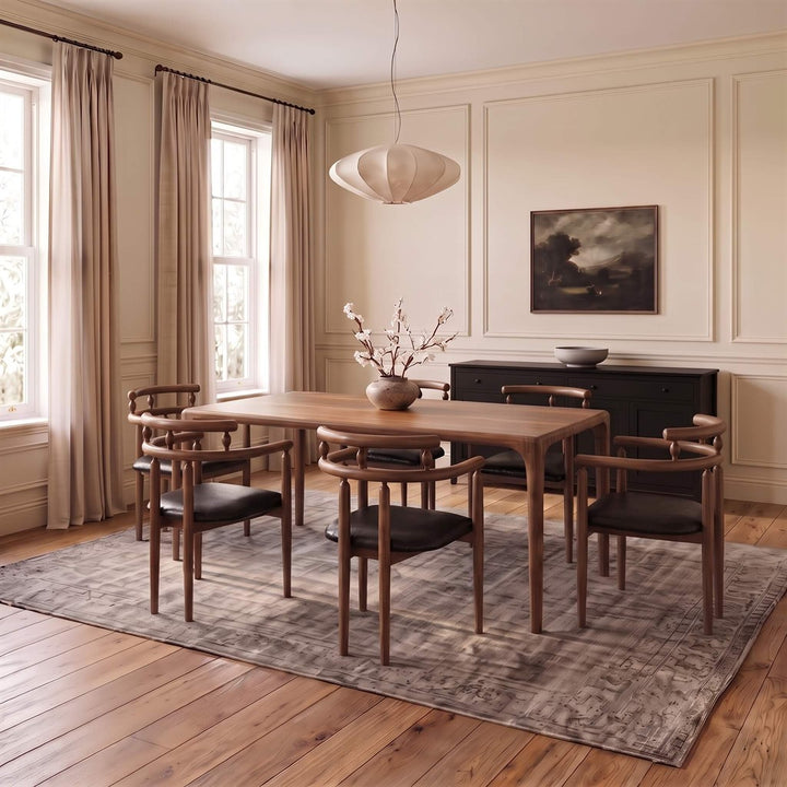 Scandinavian design solid walnut dining chair featuring curved armrests and upholstered seat   