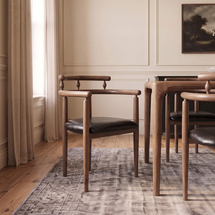 Copenhagen dining chair made of solid walnut wood featuring curved spindle backrest and padded seat cushion   