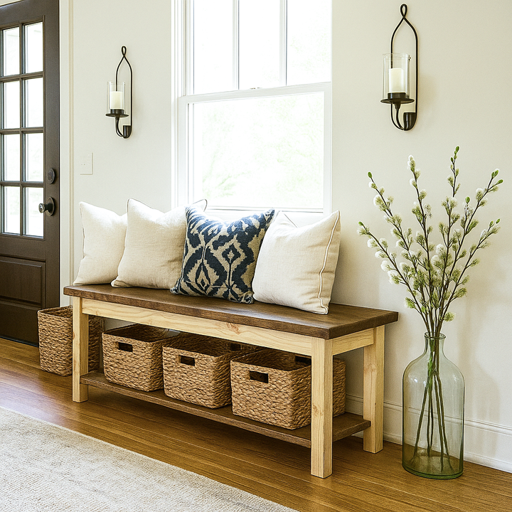 Wooden bench with storage baskets and pillows in a home entryway.