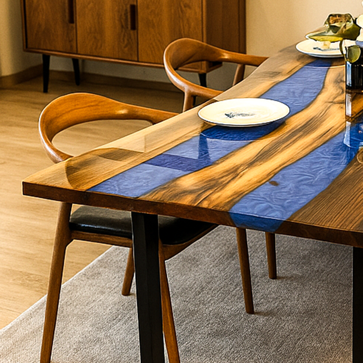 Dining table with blue resin accents and wooden chairs in a room setting.