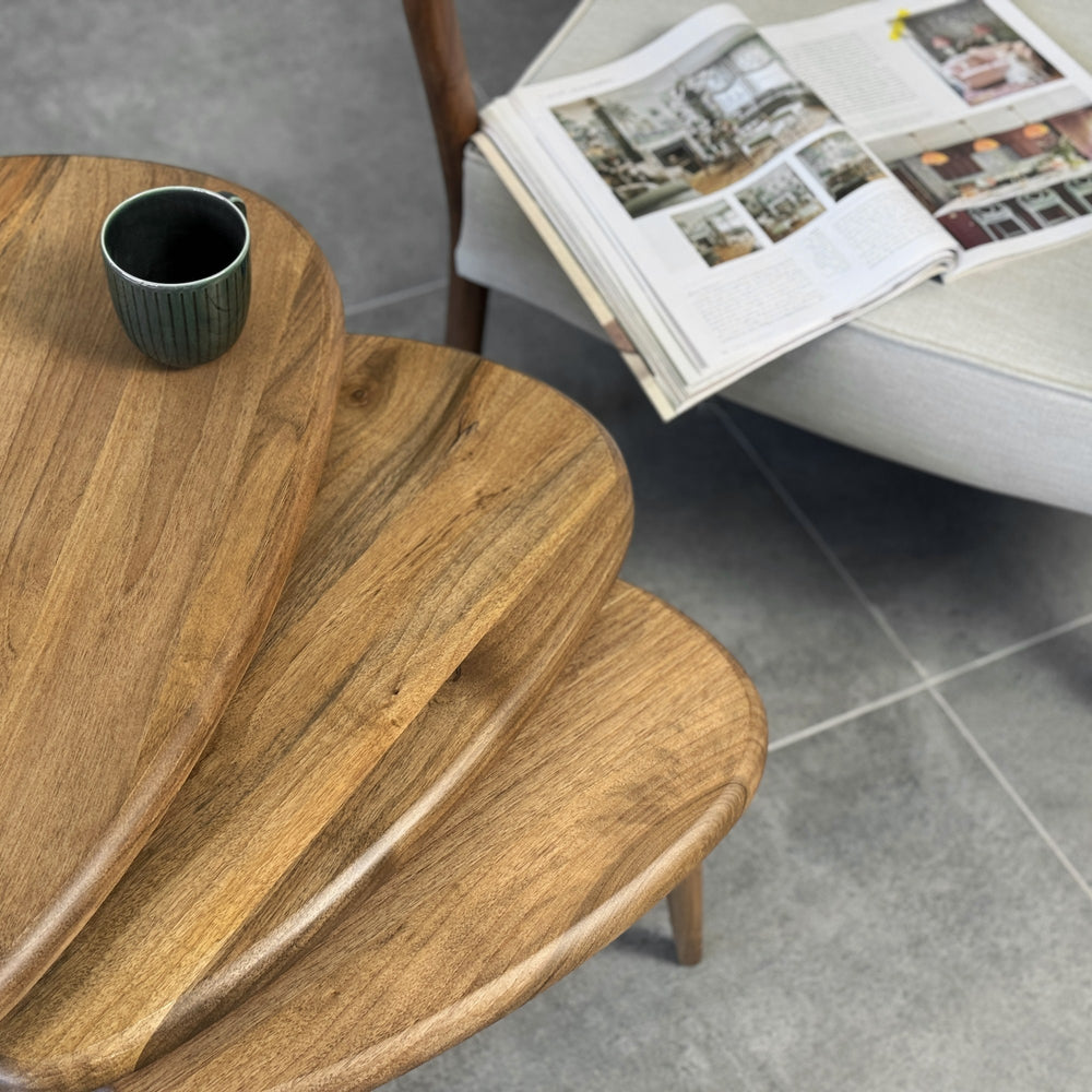 Close-up of the rounded edges on the three stacked walnut pebble style nesting tables