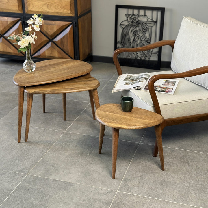 Walnut Ercol style pebble nesting tables with the smallest pulled out in front of an armchair, Set of 2 and 3 views