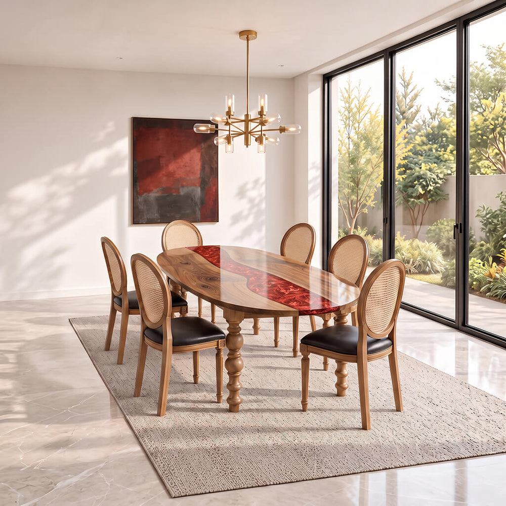 Garnet oval epoxy river dining table in solid walnut, set with six cane back chairs in a bright dining room