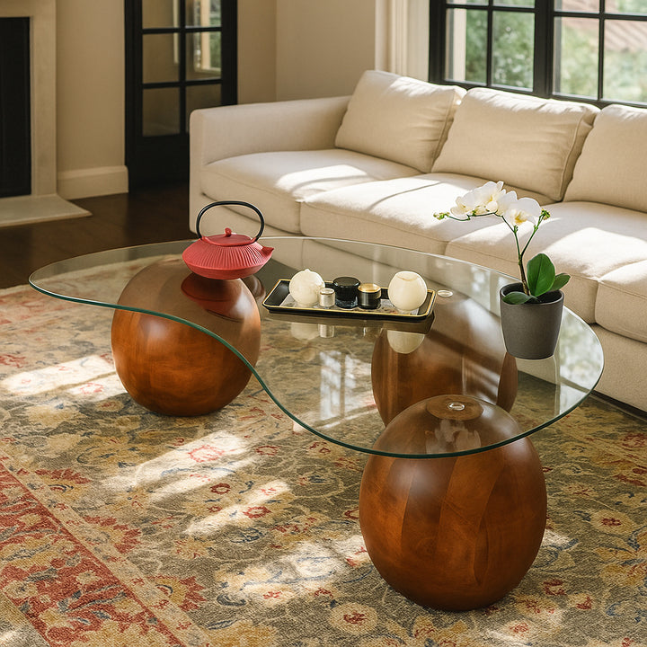 Glass coffee table with decorative items in a living room setting