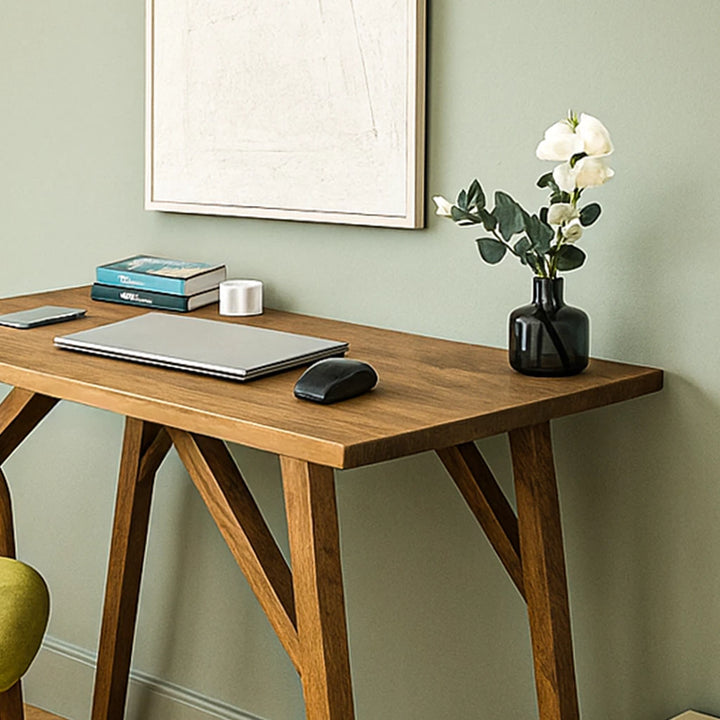 Handmade walnut desk with a laptop and chair, designed for small office spaces, showcasing solid wood craftsmanship.