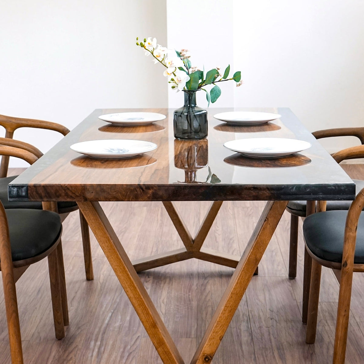 Low front view of the walnut dining table showing the V shaped legs and Y shaped foot