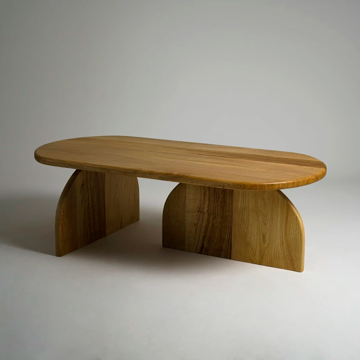 Chestnut Japandi coffee table, three-quarter view on a plain gray background