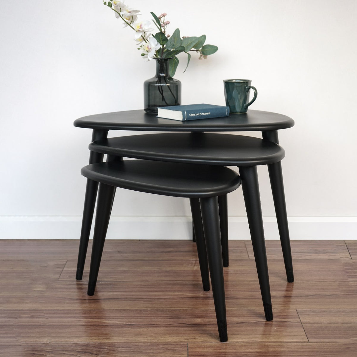 Matte black nesting table set of 3 from a low front angle showing the three heights