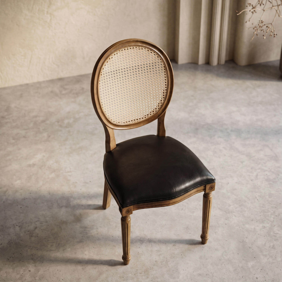 Black leather seat beechwood dining chair seen from above, with the cane back and turned front legs