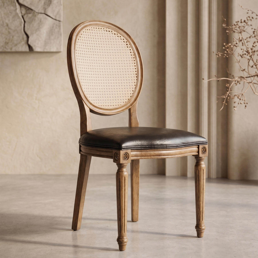 Beechwood dining chair with an oval cane backrest and black leather seat, three-quarter view