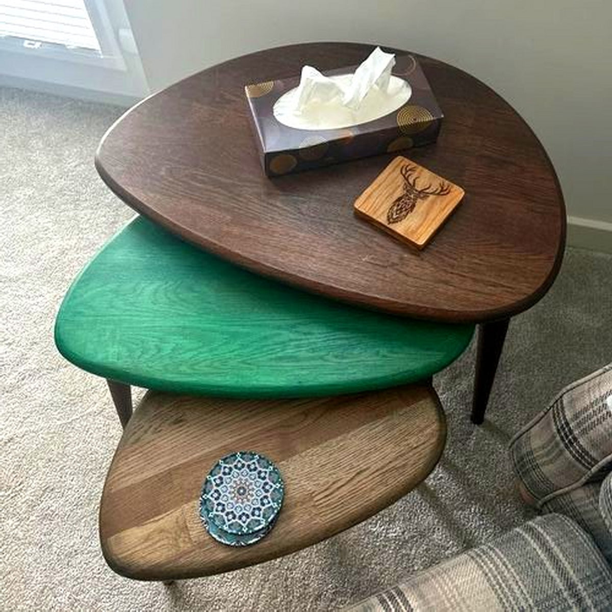 Multicolor oak nest of tables with chocolate, green and natural oak tops and a tissue box on top
