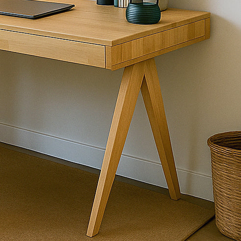Wooden desk with a minimalist design against a neutral wall.
