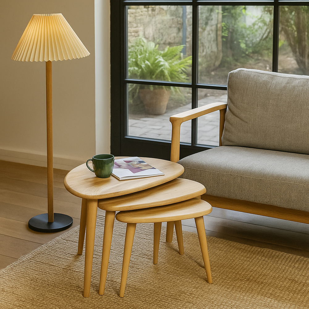 Nest of wooden tables with a lamp and sofa in a living room setting