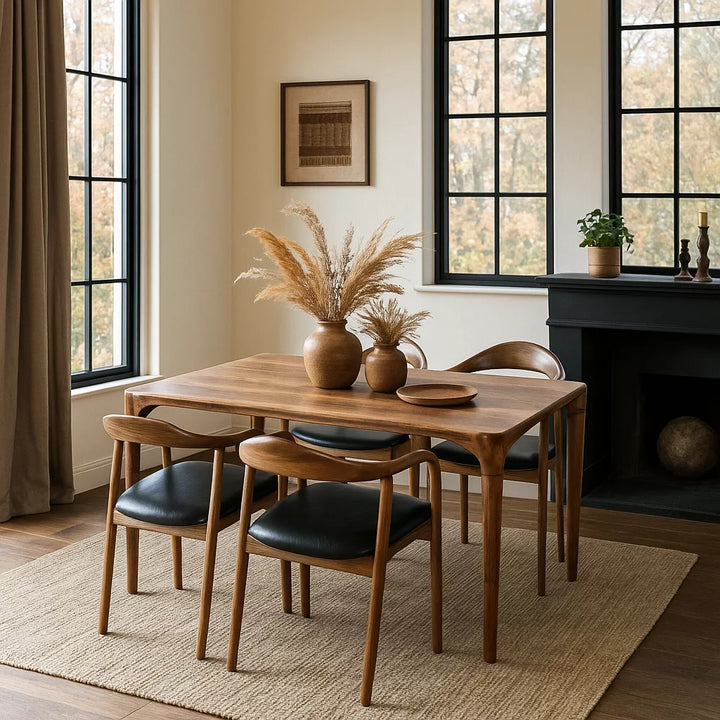 Oslo Solid Walnut Dining Table featuring a modern Scandinavian design with a sleek, curved wooden top.