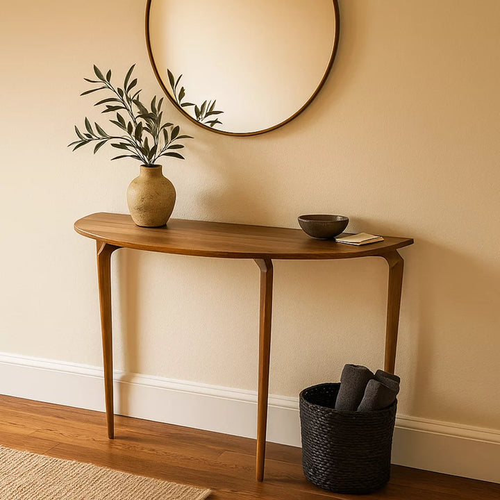 A round entryway table positioned beneath a round mirror on the wall, creating a stylish focal point in the entryway.