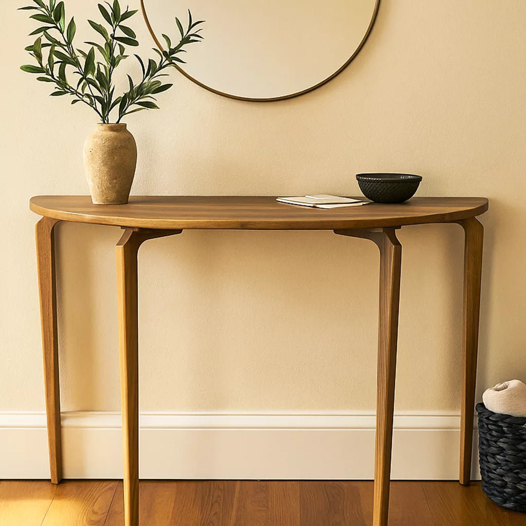 Walnut half-round console table with tapered legs, close front view with a vase on top