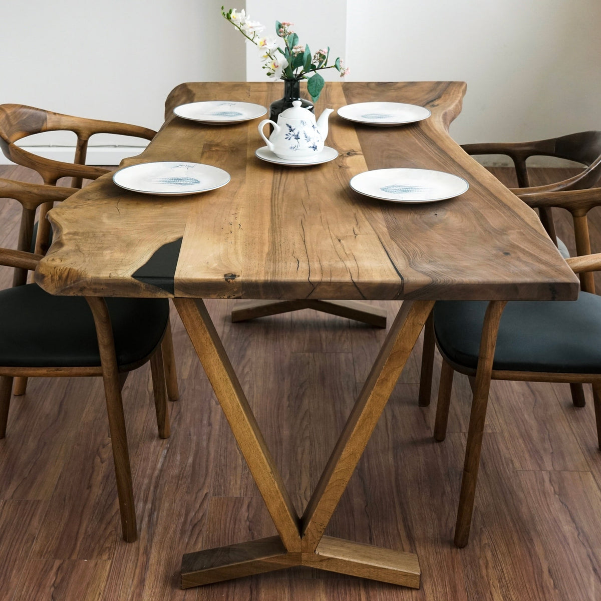 Front view of the V-shaped wooden base under the walnut live edge farmhouse table