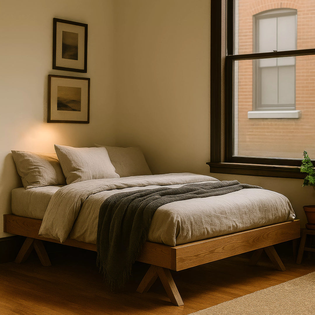 A stylish Scandinavian bed frame featuring a warm light on the bed, enhancing the inviting ambiance of the space.