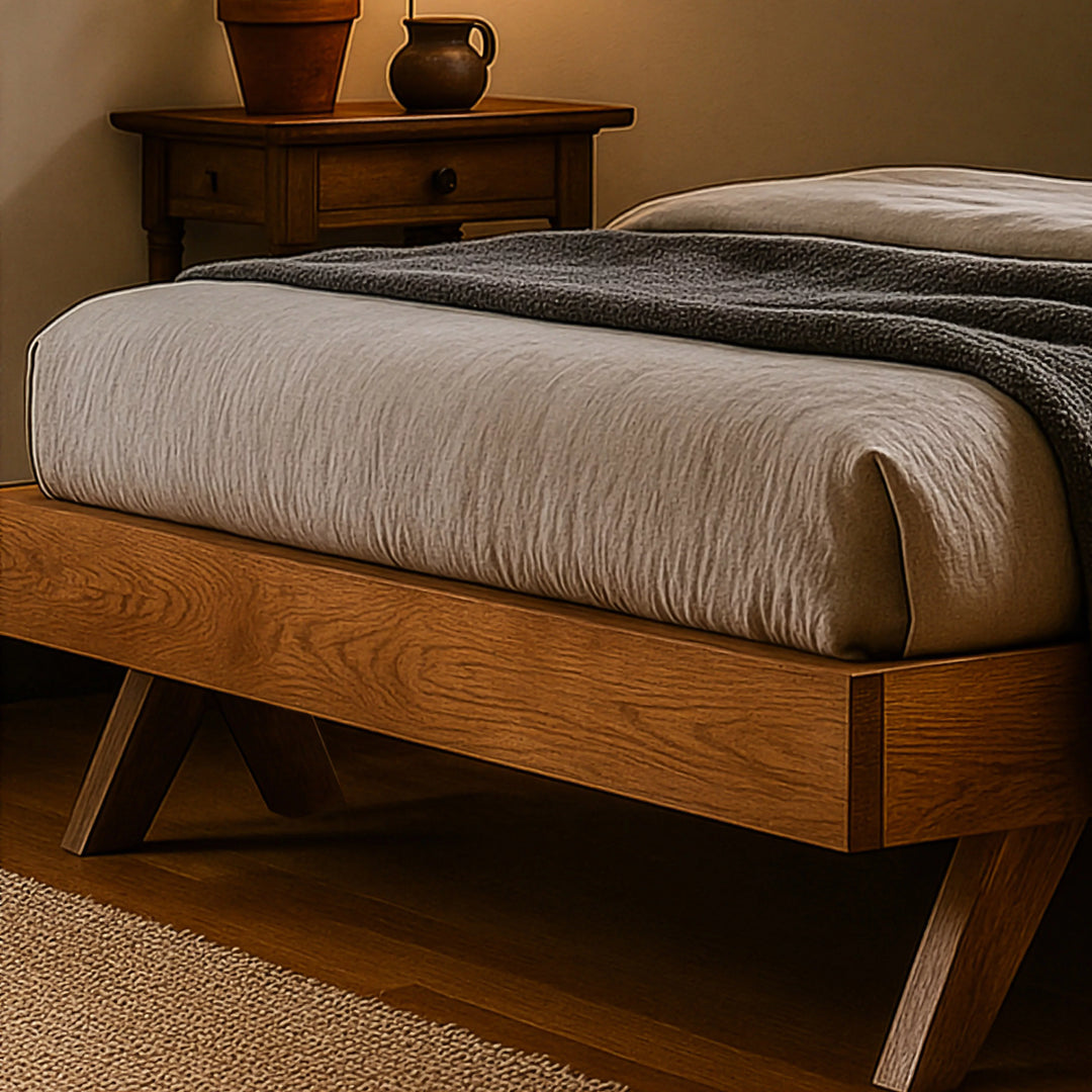 A stylish Scandinavian bed frame made of wood, next to a bedside table, enhancing the room's modern aesthetic.