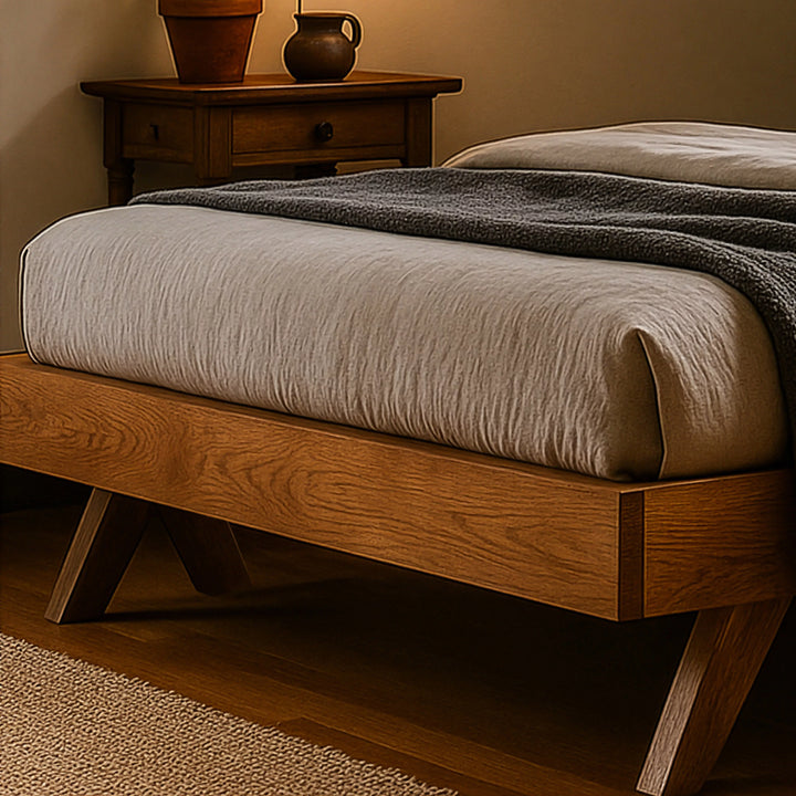 A stylish Scandinavian bed frame made of wood, next to a bedside table, enhancing the room's modern aesthetic.
