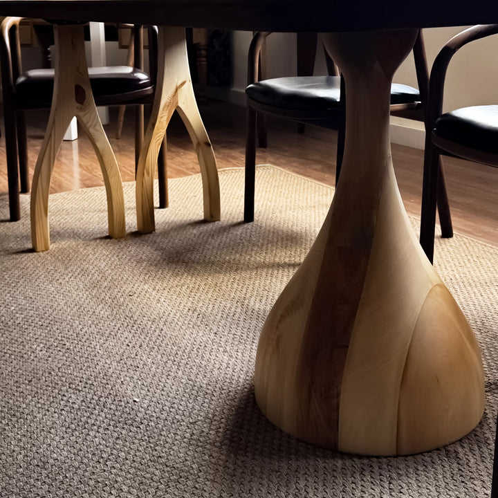 Sculptural dining table — solid walnut top with handcrafted linden wood legs in organic forms