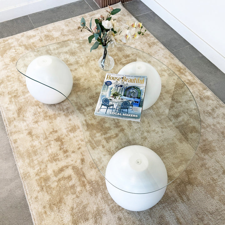 sculptural-glass-top-coffee-table-white-wooden-feet-upphomestore